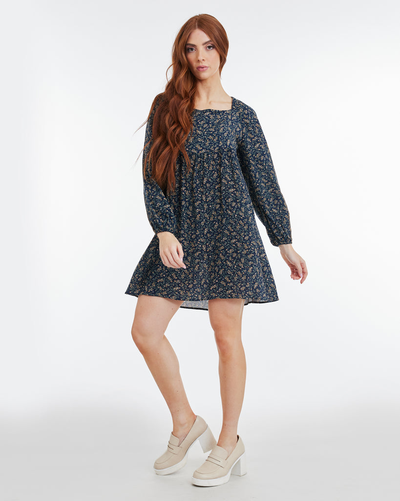 Woman in a navy floral, long sleeve, mini dress