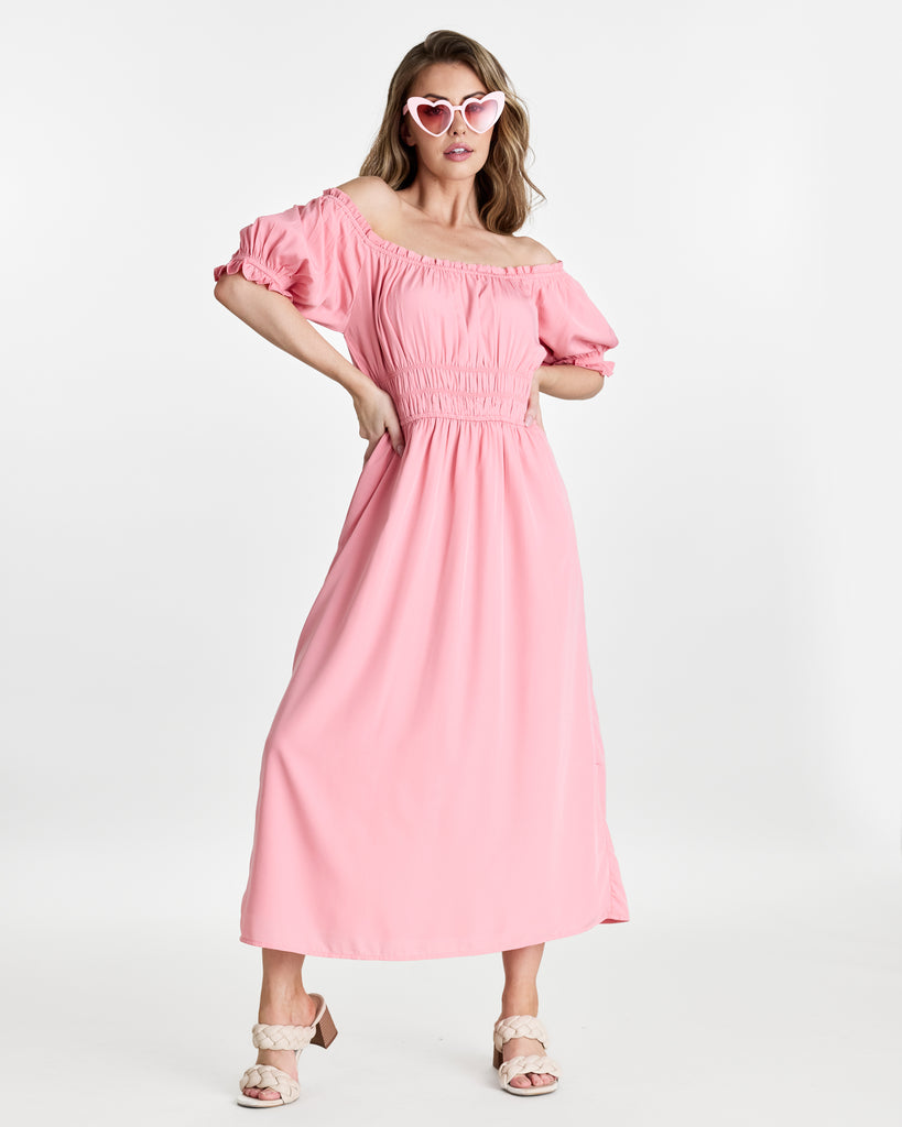 Woman in a short sleeve, off the shoulder, midi-length dress