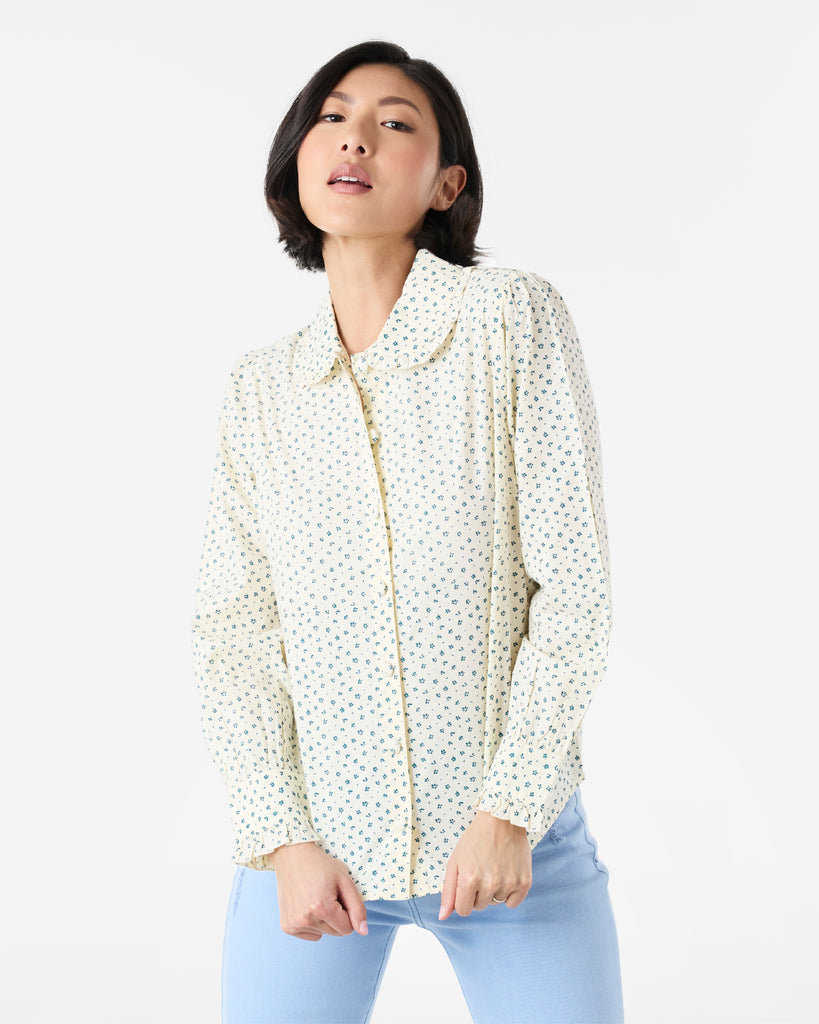 Woman in a white and blue long sleeve, collared, button-down