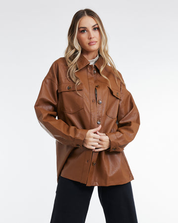 Woman in a brown, faux leather, long sleeve jacket