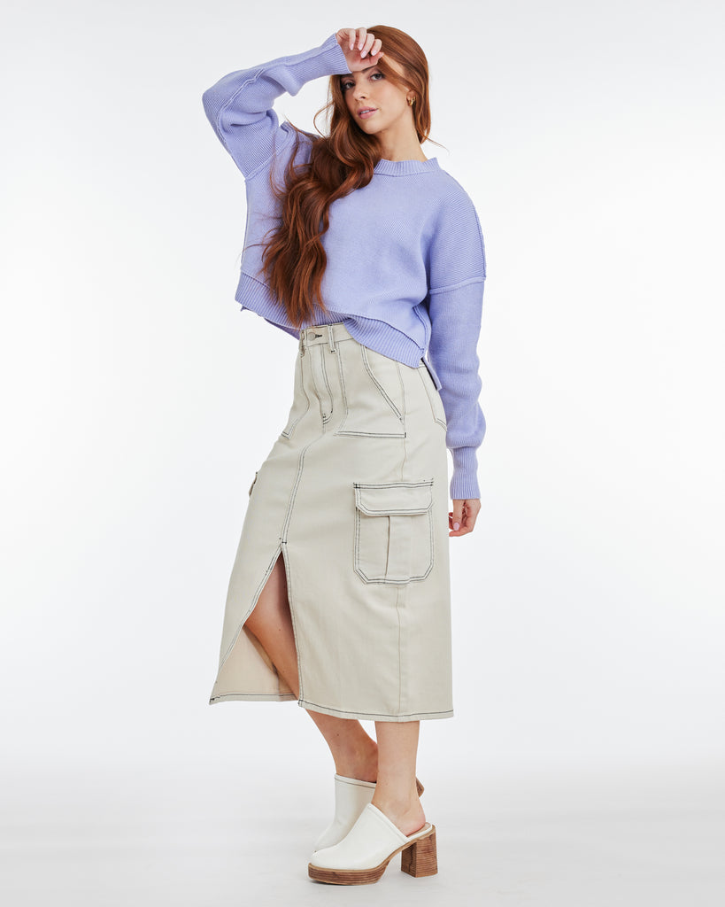 Woman in grey denim skirt with front slit