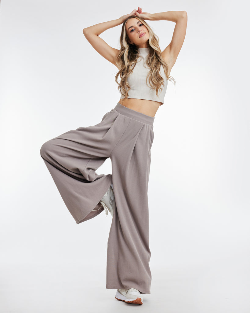 Woman in taupe, wide leg stretchy pants