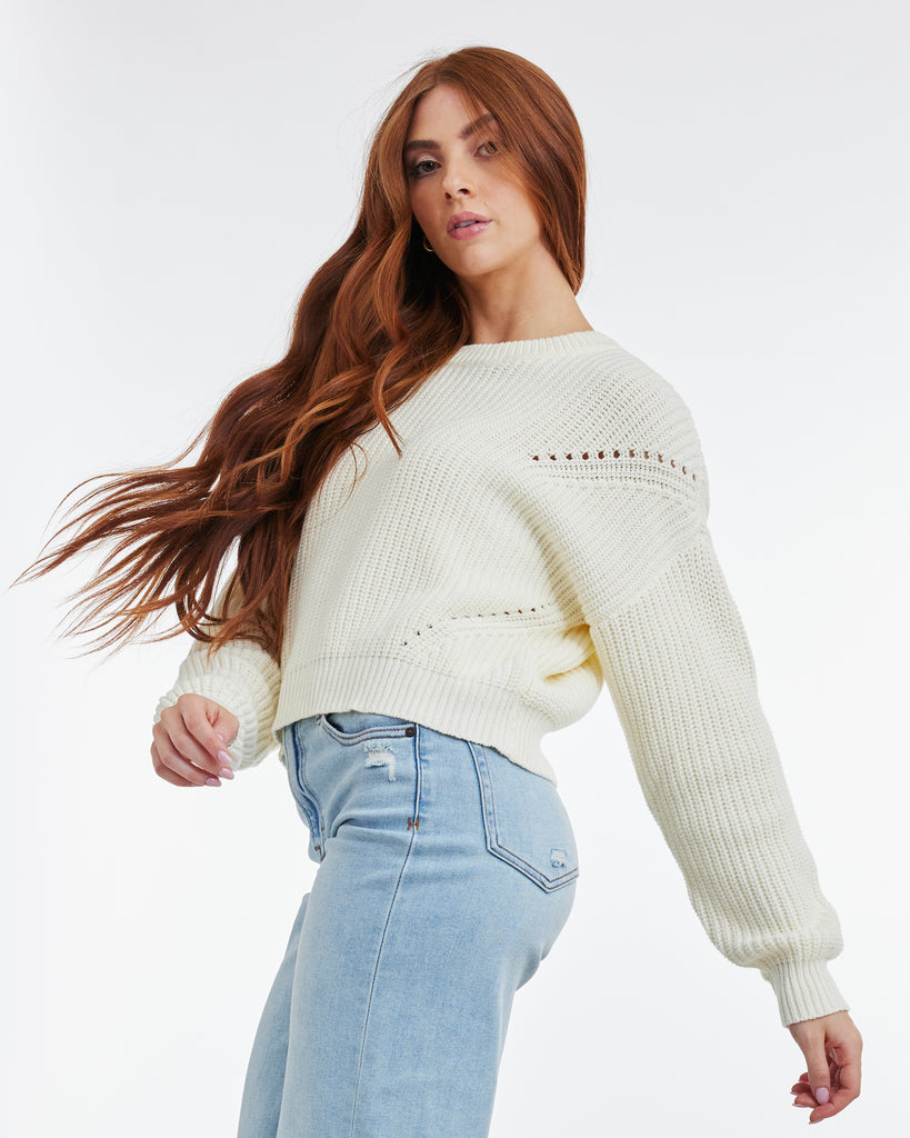 Woman in a white long sleeve sweater
