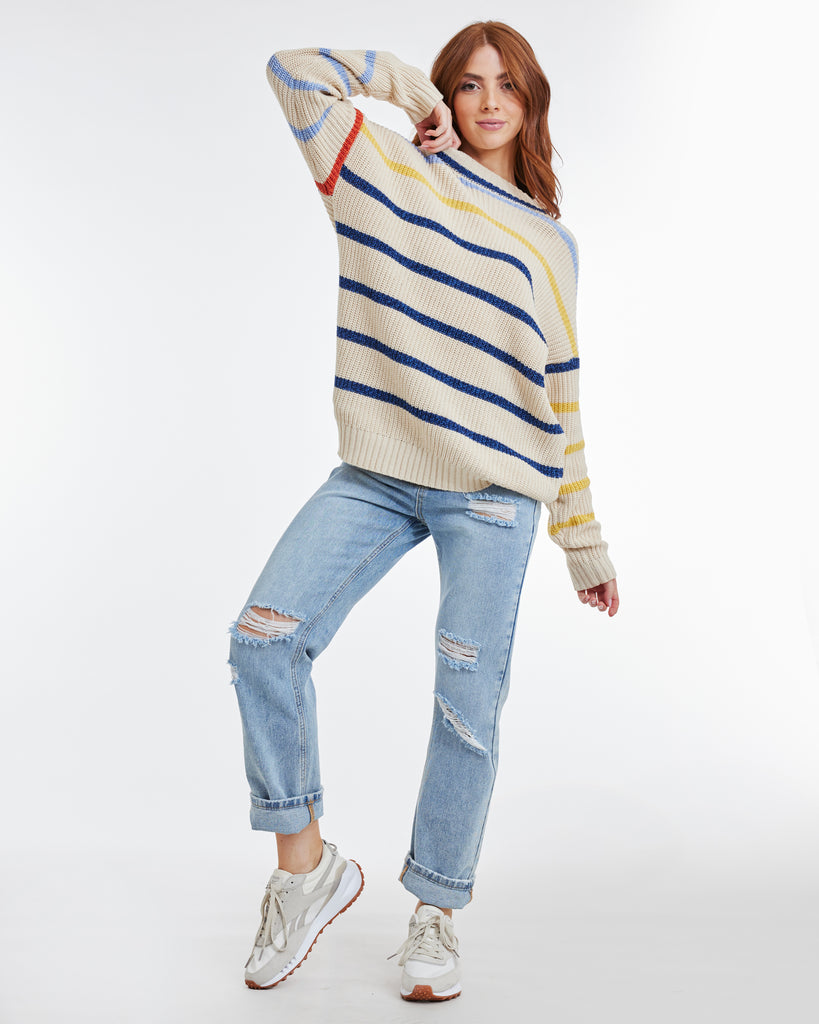 Woman in a blue and yellow striped long sleeve sweater