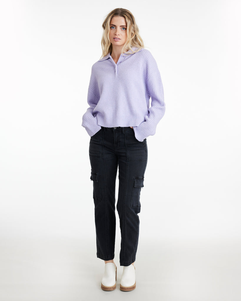 Woman in a lavender, long sleeve, ribbed, collared sweater
