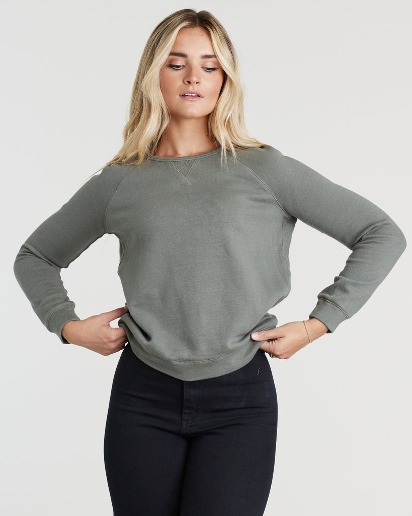 Woman in a dark gray, long sleeve sweatshirt