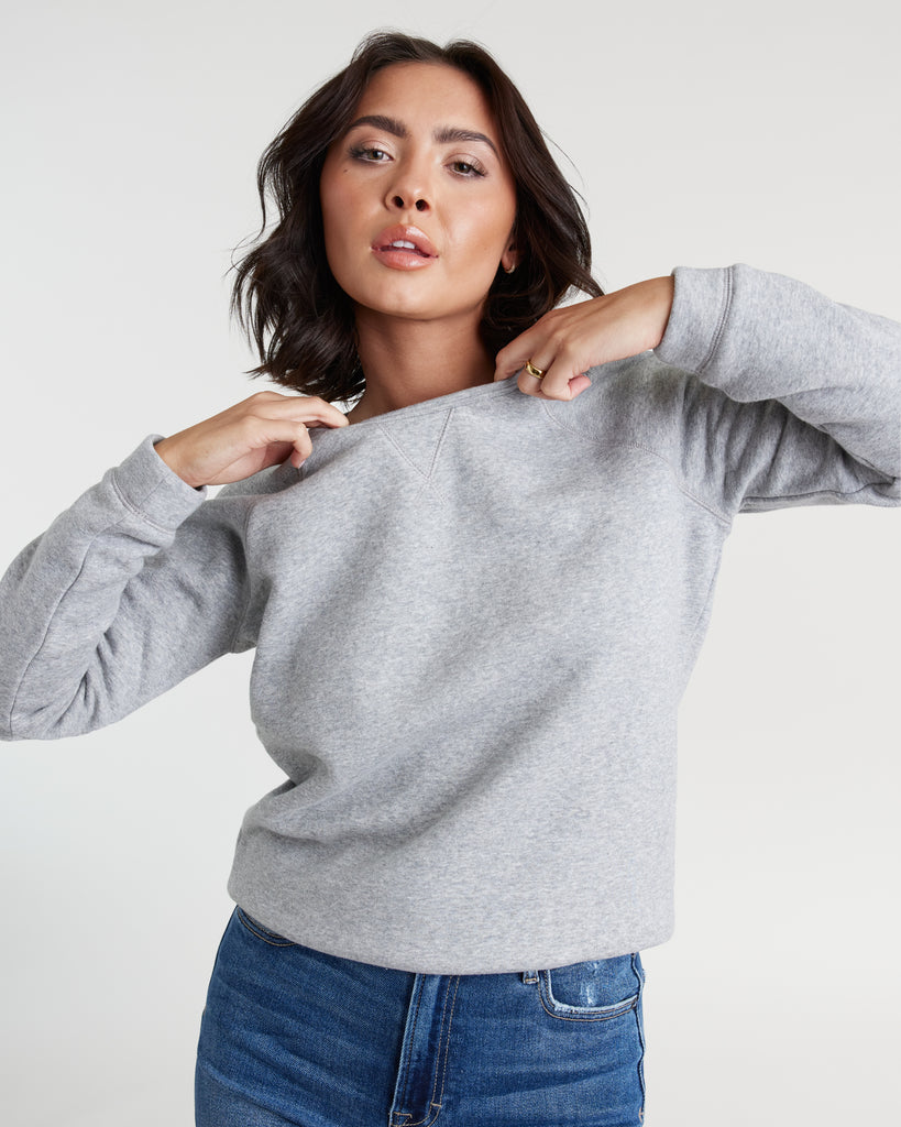 Woman in a gray, long sleeve sweatshirt