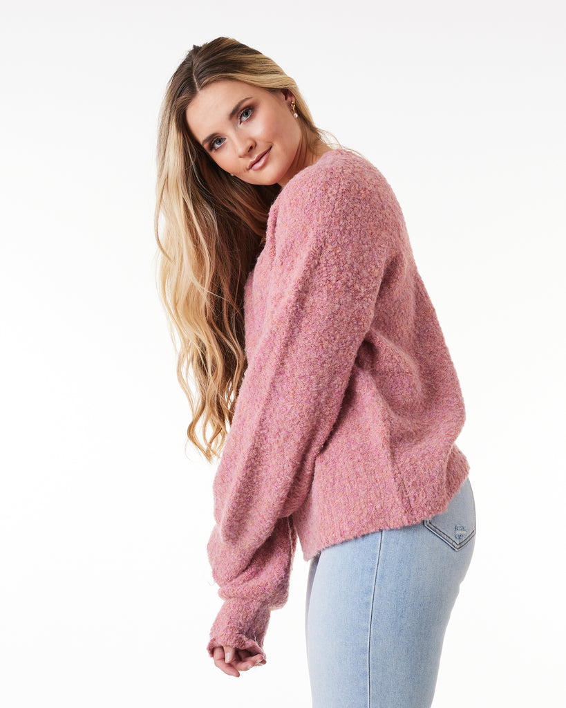 Woman in a pink long sleeve sweater