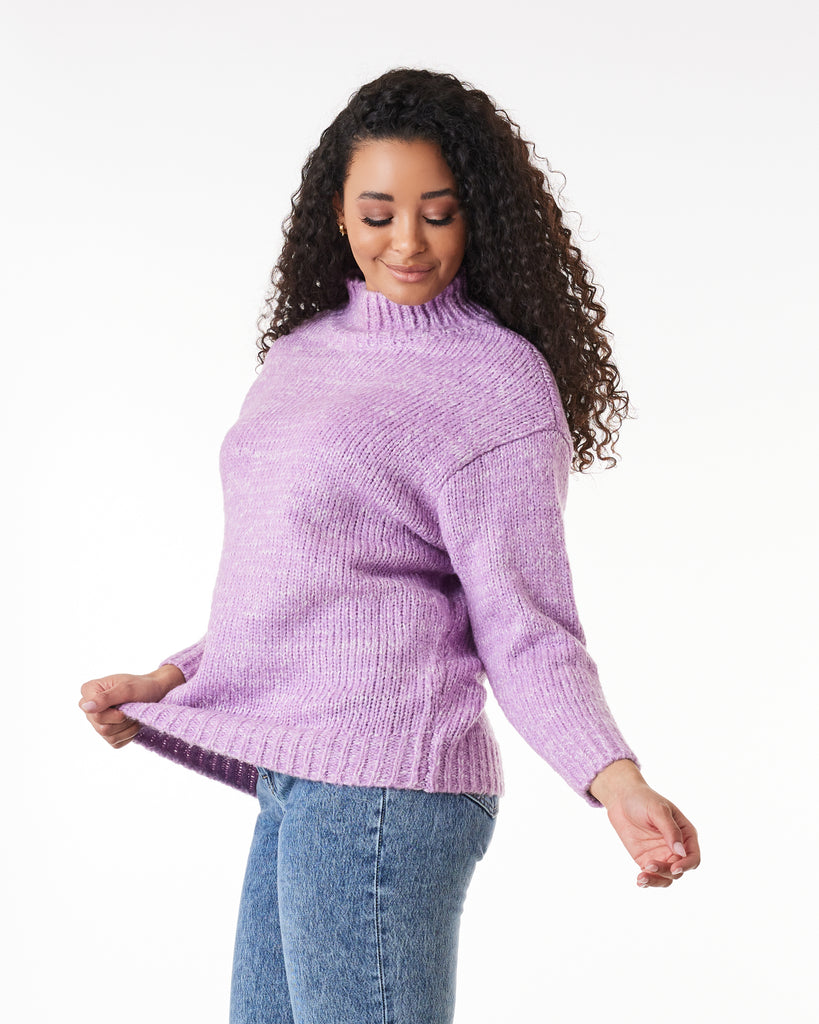 Woman in a purple long sleeve mock-neck sweater