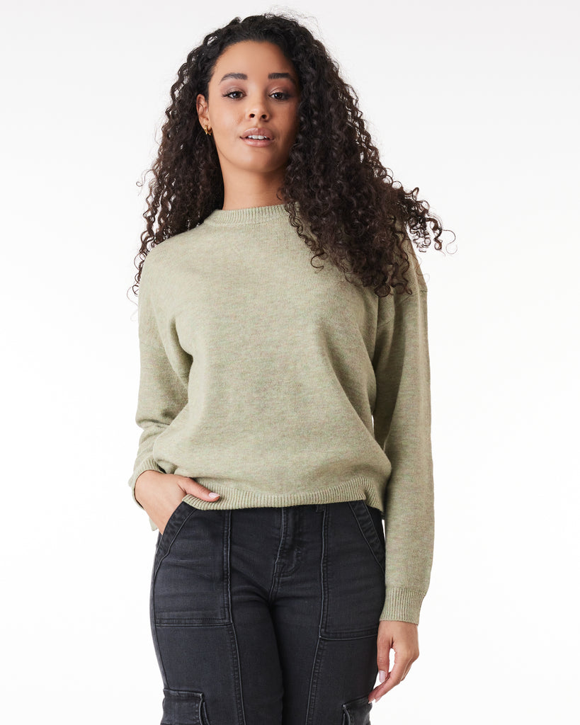 Woman in a green, long sleeve sweater