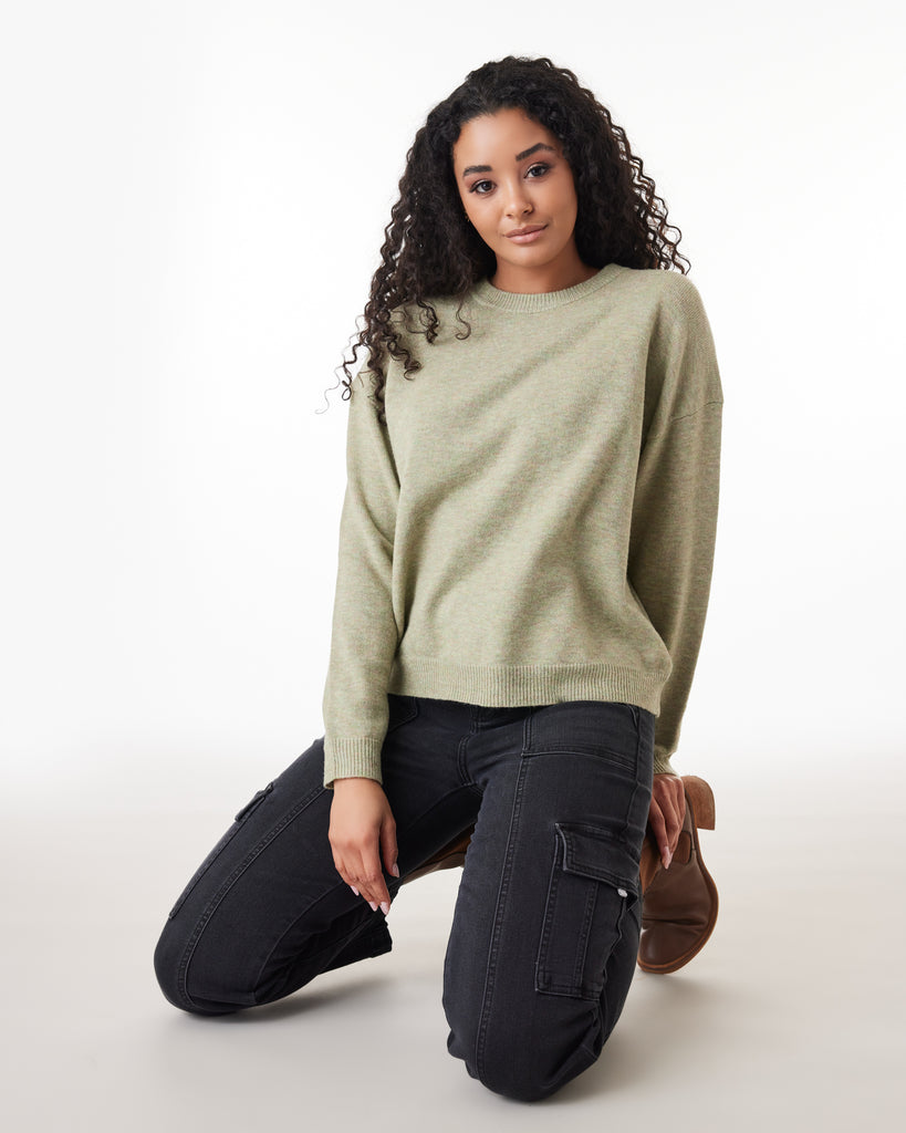 Woman in a green, long sleeve sweater