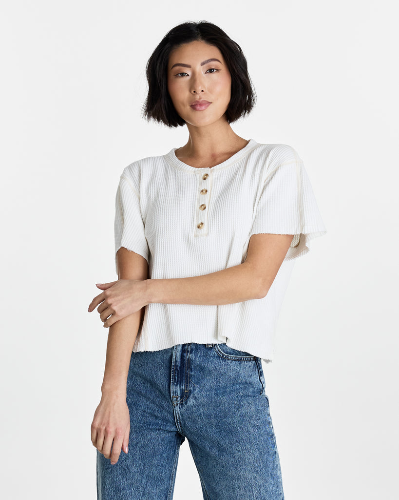 Woman in a white short sleeve henley t-shirt