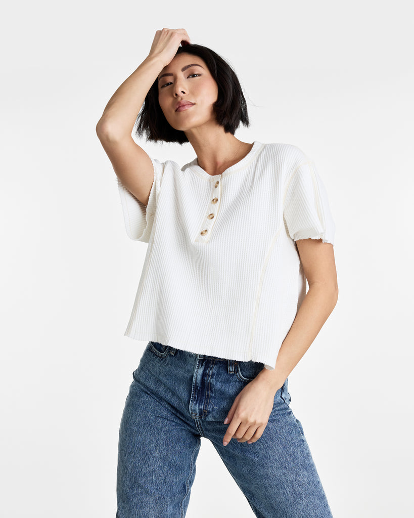 Woman in a white short sleeve henley t-shirt