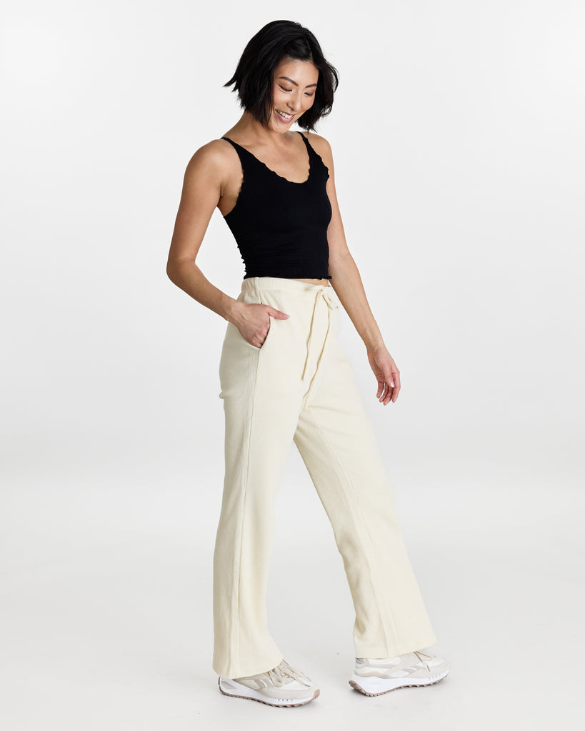 Woman in long sweatpants with tie at waist